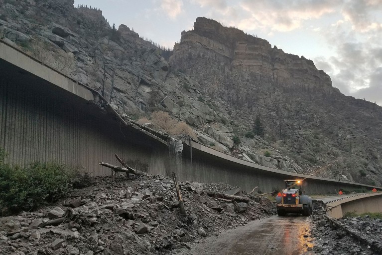 Mud and debris from a mudslide on Interstate-70 through Glenwood Canyon, Colorado, US has broken a guardrail and is in the road.
