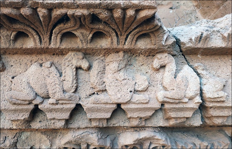 Two-humped camels flanking a royal portrait in the centre of the lintel on a wall, circa second-century AD in Hatra, Iraq.