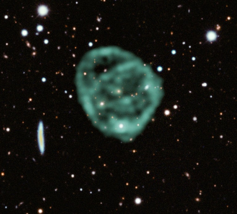 MeerKAT radio telescope data (green) showing the odd radio circles is overlaid on optical and near infra-red data.