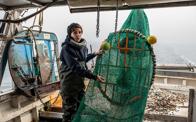 Laura Aiudi, marine biologist on a trawler off Cesenatico's coast, testing the turtle excluder modified net.