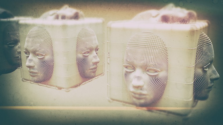 Cubes with computer-generated human faces on each side sit next to each other