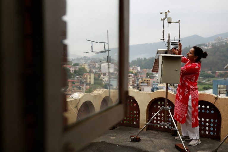 Hemu Kafle checks on one of the low-cost meteorological stations on the roof of the the Kathmandu Institute of Applied Sciences