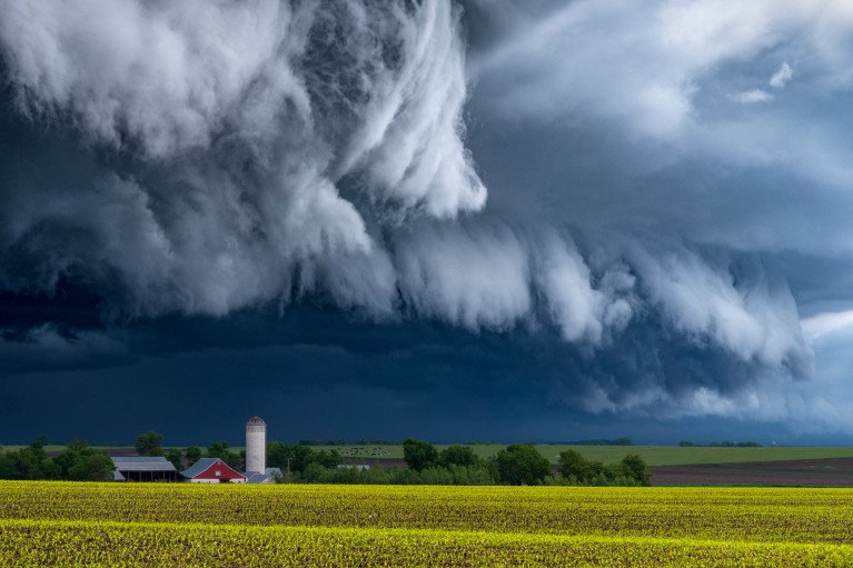 Tall dark storm clouds over farm buildings and fields in Minnesota