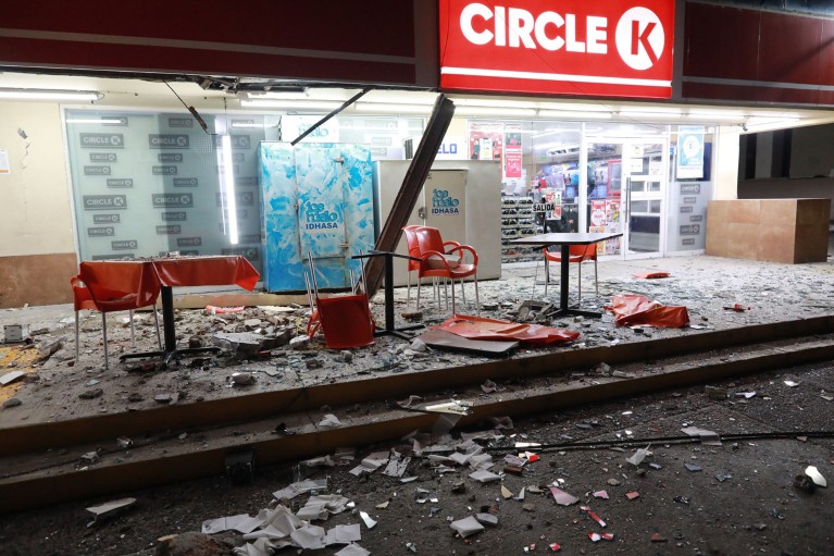 Outside view of the damage to a Circle K building at night