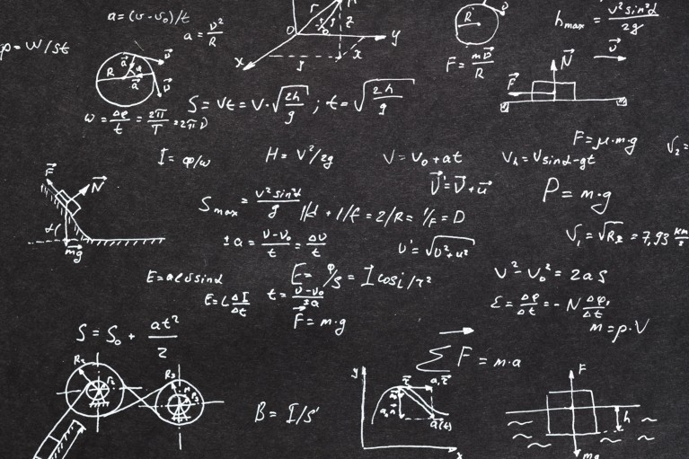 A black chalkboard showing a physics formula in white chalk
