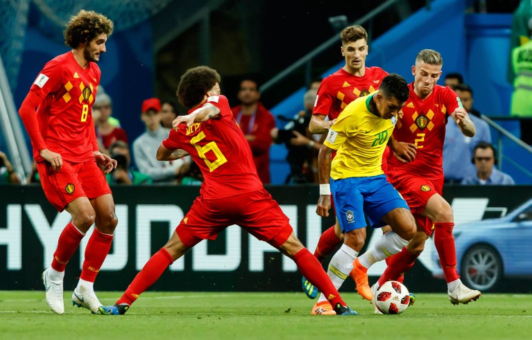 Axel Witsel of Belgium, Toby Alderweireld of Belgium and Roberto Firmino of Brazil battle for the ball, 2018 FIFA World Cup.