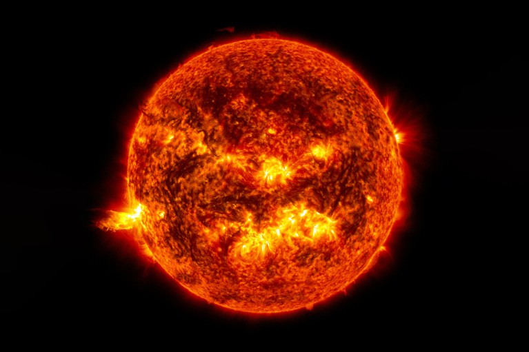 An image of the Sun showing a bright solar flare and a large eruption of solar material.