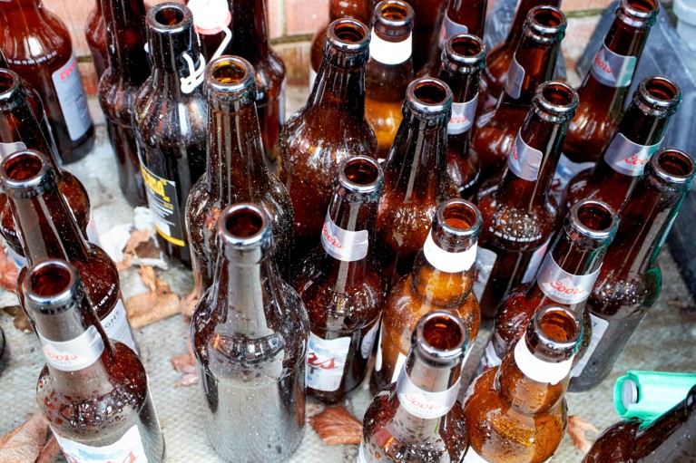A large collection of empty brown beer bottles