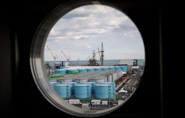 Observatory room shows reactor buildings and storage tanks for contaminated water at Fukushima nuclear plant.