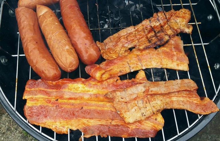 BBQ with bacon and sausages on top.