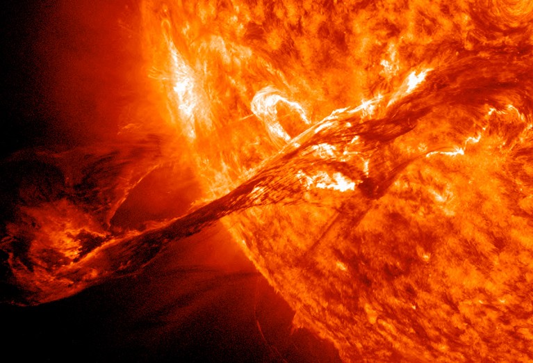 Ultraviolet (UV) satellite image showing a solar flare and coronal mass ejection (CME) erupting from the surface of the Sun.