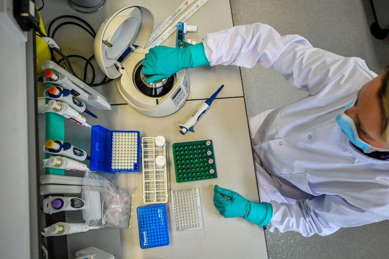 A virologist prepares solutions inside a lab at The Defence Science and Technology Laboratory in Wiltshire.