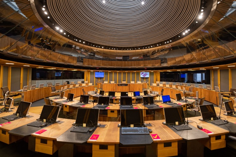 An interior view of the Welsh Parliament debating chamber showing rows of computer screens