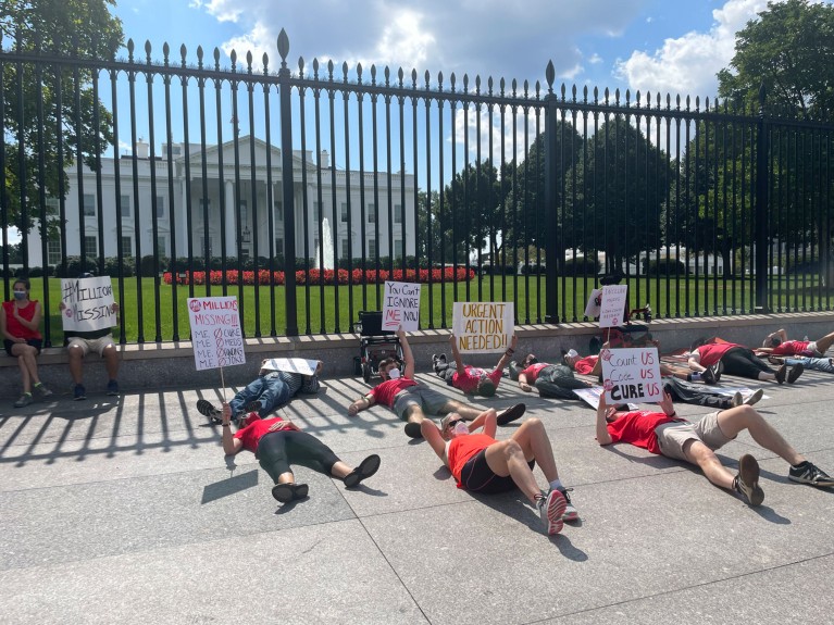 People protest demanding action on chronic fatigue syndrome and long COVID-19 in front of the White House