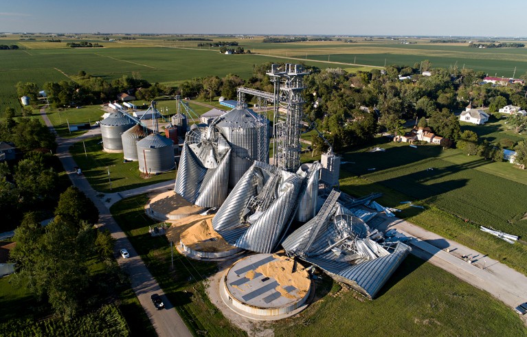 In this drone image, damaged grain bins are shown at the Heartland Co-Op grain elevator in Luther, Iowa.