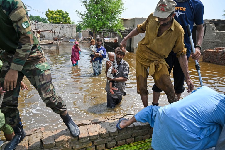 Pakistan's Naval personnel rescue flood-affected people from their damaged houses