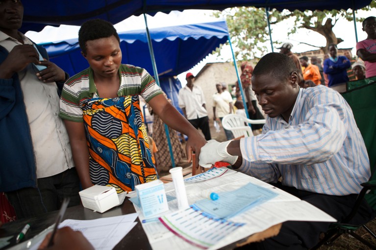 A patient is getting tested for HIV and AIDS at a mobile outreach clinic in Uganda