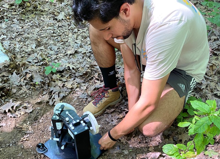 Oberlin College student Eduardo Castro Muñoz sets up a magnetometer in Findley State Park in Ohio.