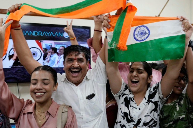 Indian people smile and celebrate the successful landing of Chandrayaan-3