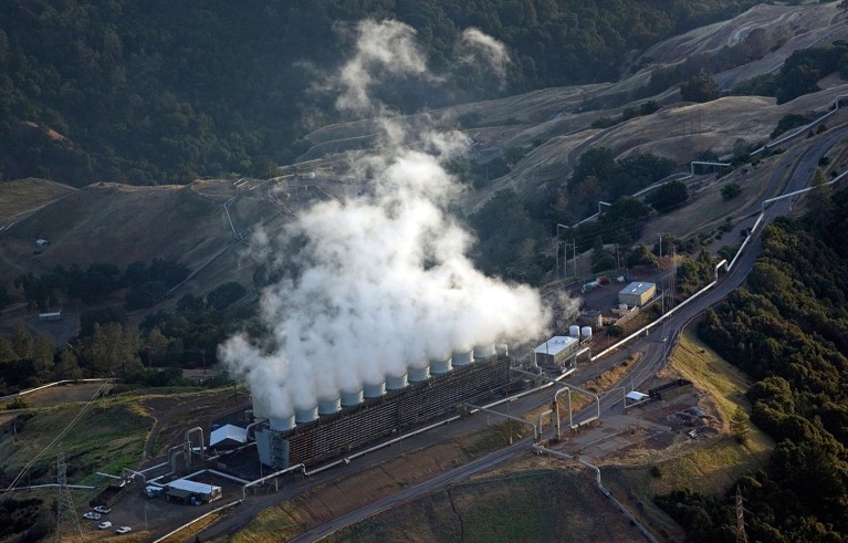 Aerial above the Geysers largest group of geothermal power plants in the world northern California.