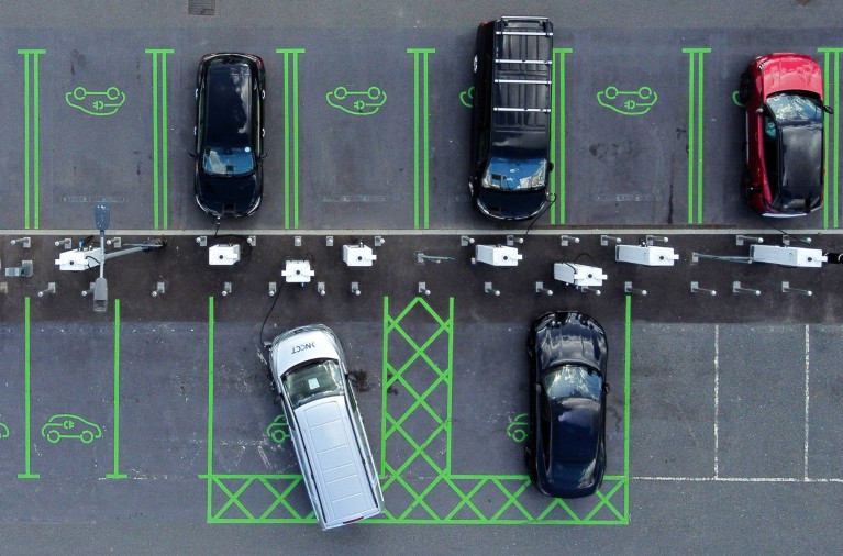 Overhead aerial view of electric vehicles plugged in at a Gridserve charging hub