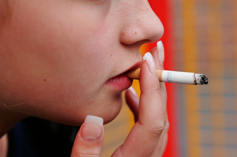 Close up image of a teenager smoking a cigarette in London.