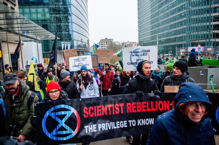 Protesters from the group Scientist rebellion are seen marching with banners and boards