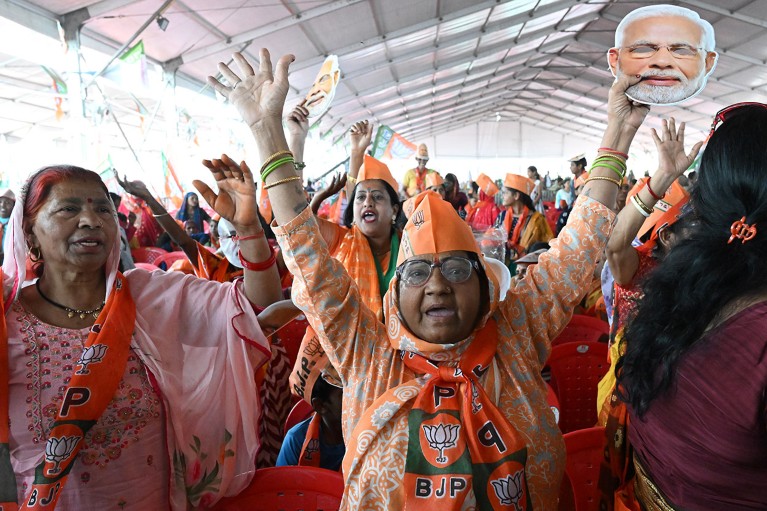Supporters of the Bhartiya Janata Party (BJP) wave masks of Prime Minister Narendra Modi's face during a rally in Meerut, Uttar Pradesh, India.