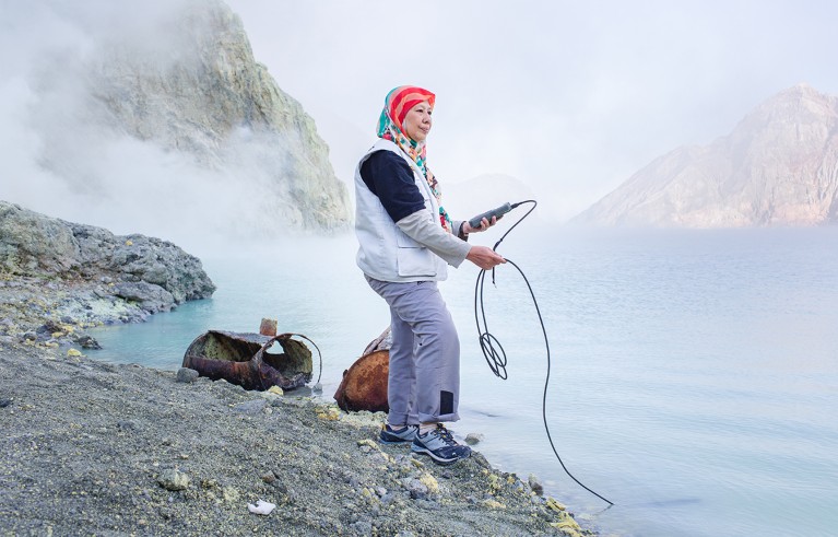 Hanik Humaida measures the ph of the water in the acidic lake inside the crater of Ijen volcano, East Java, Indonesia. Ijen is home to the biggest acidic lake in the world.