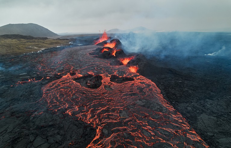 An aerial view of flowing lava and billowing smoke from volcanic eruption between stora Skogfell and Hagafell in Reykjanes Peninsula of Iceland on March 21, 2024.
