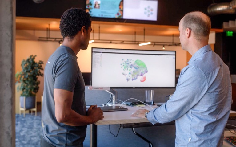 Two memers of the Chan Zuckerberg Initiative team demonstrate the Cell by Gene platform on a desktop computer
