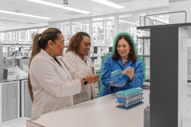 Amanda Black, outlined in teal, pictured with two students while working in the lab.