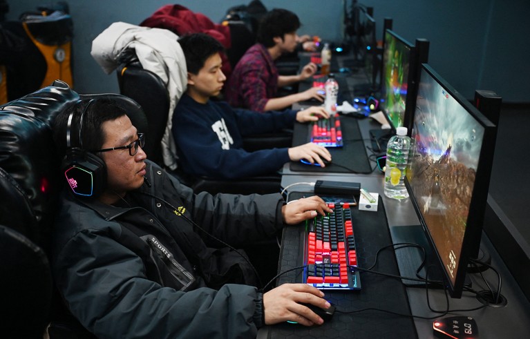 People play computer games at an internet cafe in Beijing.