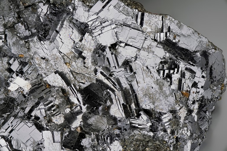 Close-up of galena mineral, showing reflective silver-grey cubic crystals with sharp geometric faces and a metallic texture