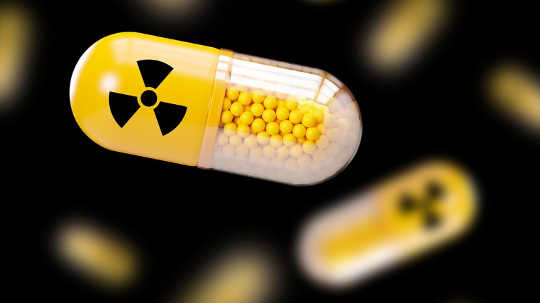 A yellow pill capsule with a radiation sign on its casing
