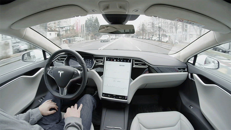 Self-driving Tesla Model S autopilot steering on urban streets.
