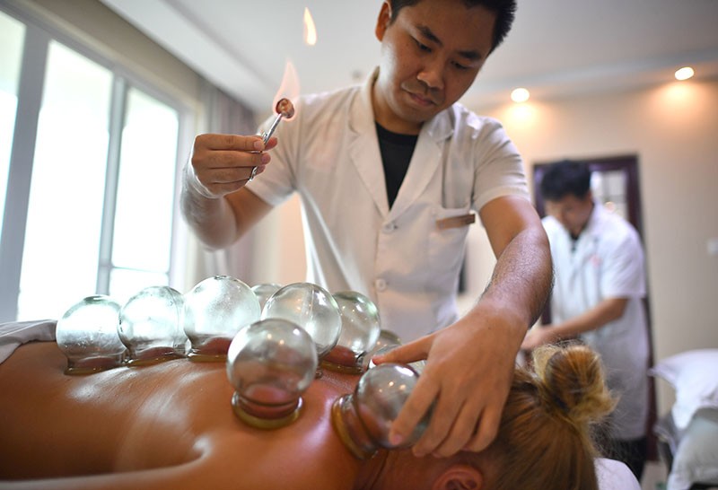 A patient is treated with heated cups at a traditional-medicine clinic in Shanghai.