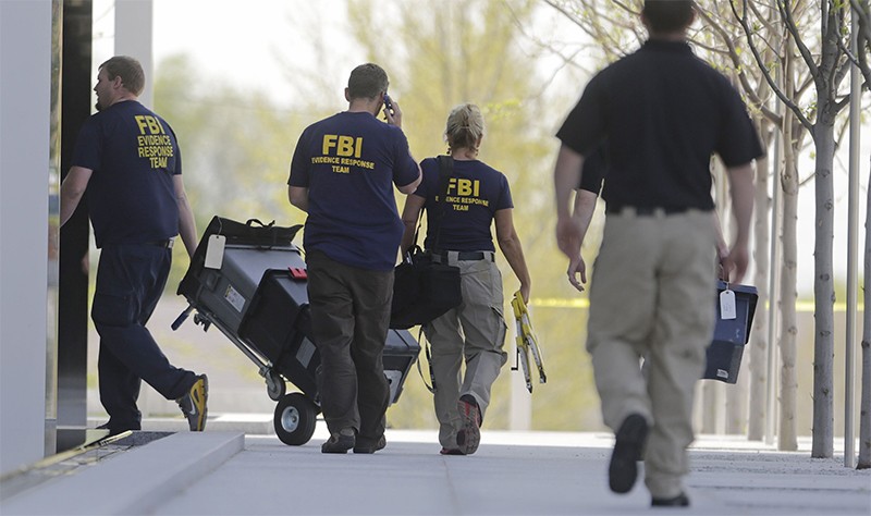 People in FBI tshirts walk into courthouse