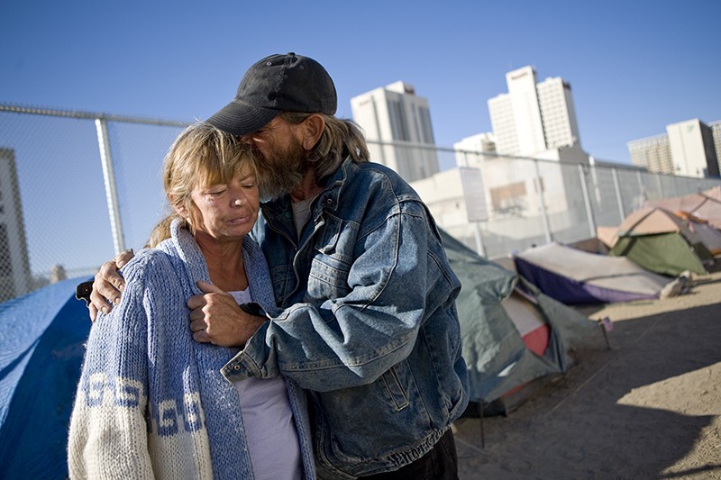 A couple hugs in in a tent city for the homeless in downtown Reno.