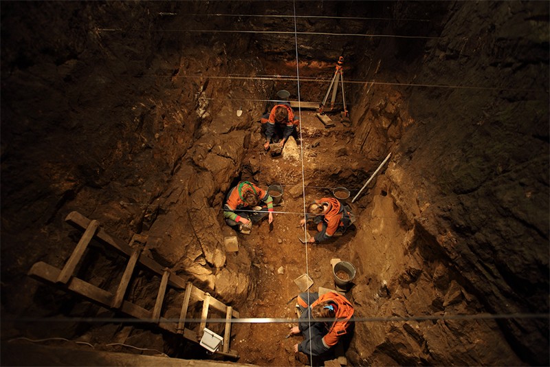 4 scientists excavating Pleistocene deposits in East Chamber of Denisova Cave, 2010.