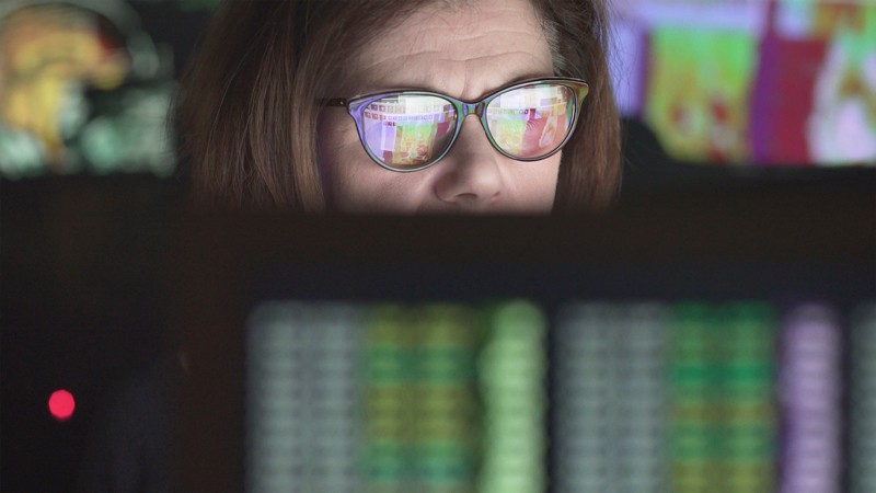 Woman looking at computer displays