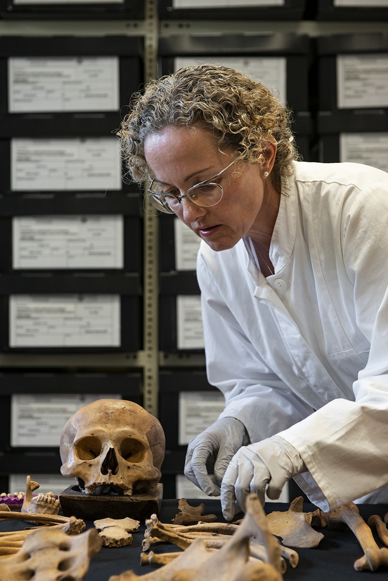 Vera Tiesler examines the remains of a person buried in Mexico during early colonial times