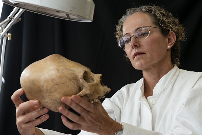 Vera Tiesler examines a Classic Maya Period skull