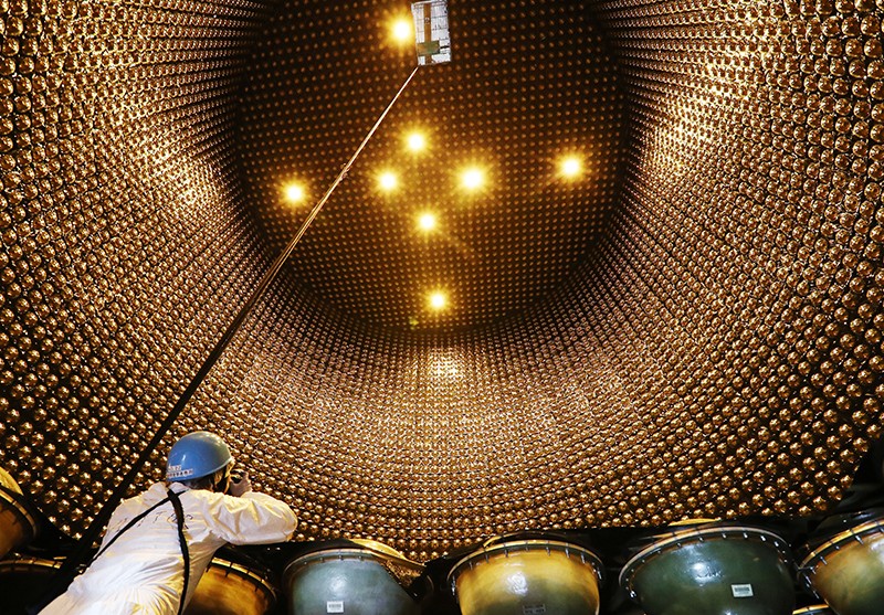 A media photographer takes photographs inside the Super-Kamiokande Neutrino Detector