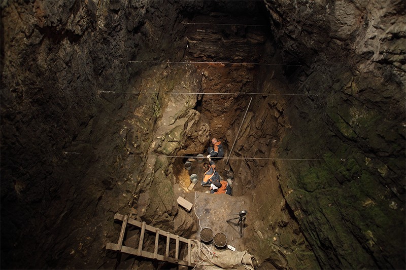 Scientists excavating hominin remains in the east chamber of the Denisova Cave in the Altai Mountains, Russia