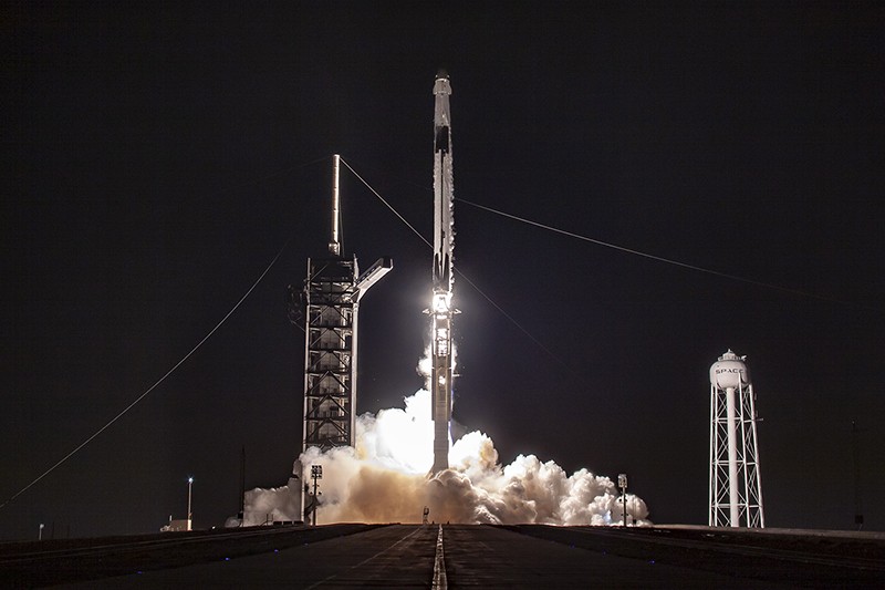 The Crew Demo-1 Mission rocket launches at night.