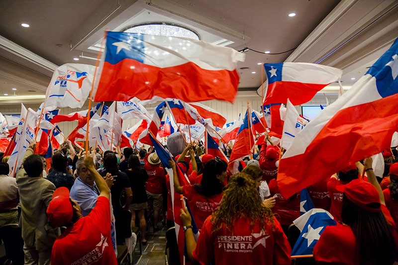 Supporters of Presidential Candidate Sebastian Piñera wave flags in Santiago, Chile