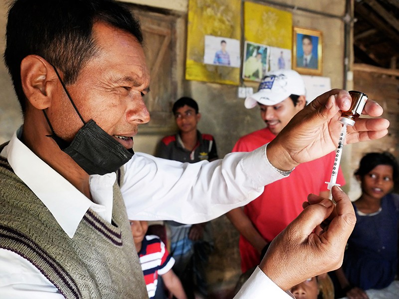 A doctor seen preparing vaccine injection for the refugee families in the Kutupalong Refugee Camp, Bangladesh.