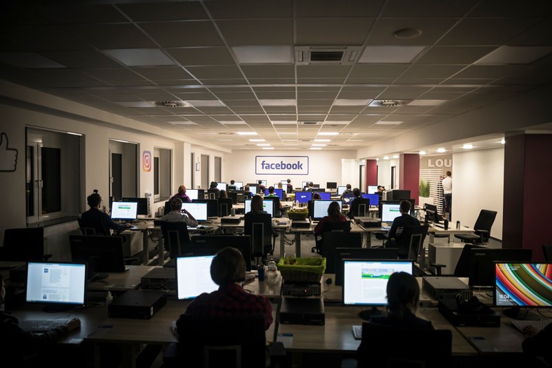 Content moderators work at banks of computers at the Facebook deletion centre in Berlin.